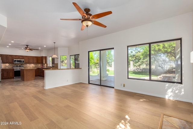 unfurnished living room featuring light wood-style floors, recessed lighting, baseboards, and a ceiling fan