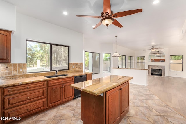 kitchen featuring pendant lighting, black dishwasher, brown cabinets, and a sink