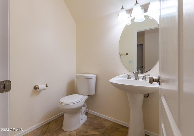 half bathroom featuring toilet, tile patterned flooring, and baseboards