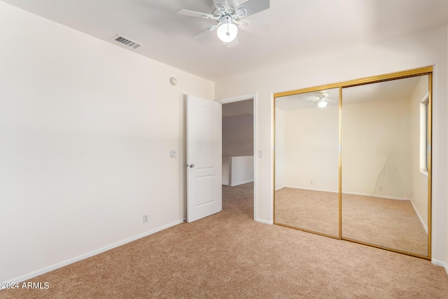 unfurnished bedroom with carpet, a closet, visible vents, and baseboards