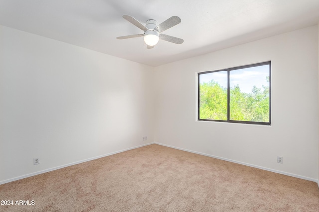 unfurnished room featuring ceiling fan, baseboards, and light colored carpet