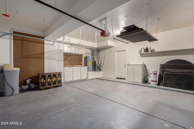 garage with electric water heater and a garage door opener