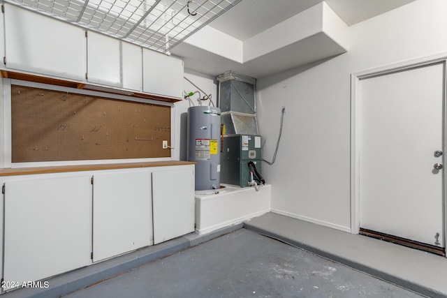 garage with baseboards, electric water heater, and heating unit