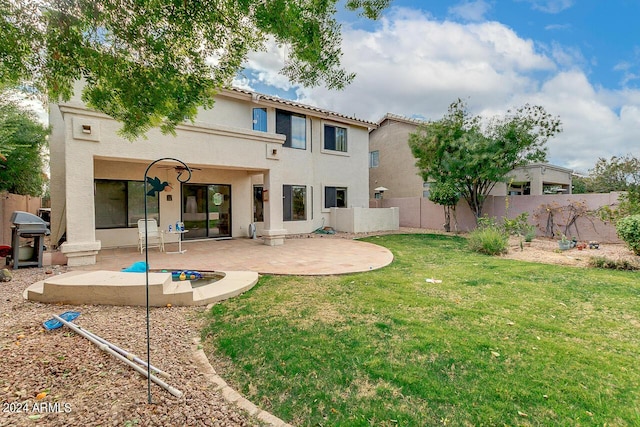 back of property featuring a patio area, a lawn, a fenced backyard, and stucco siding