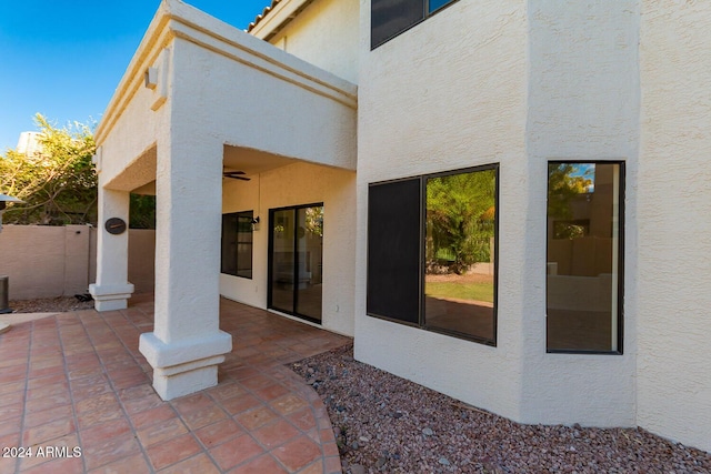 view of patio featuring fence and a ceiling fan