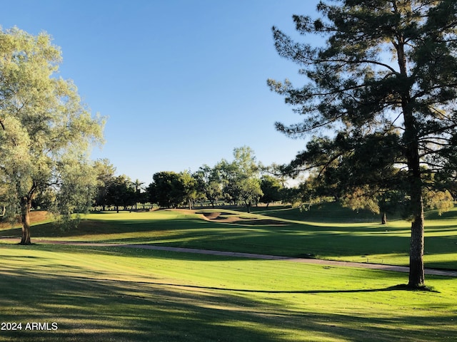 surrounding community with a lawn and golf course view