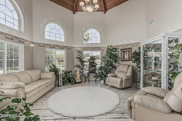 living room with visible vents, a healthy amount of sunlight, high vaulted ceiling, and wooden ceiling