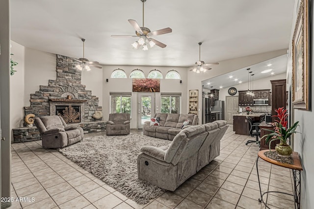 living area featuring recessed lighting, ceiling fan, light tile patterned flooring, and a fireplace