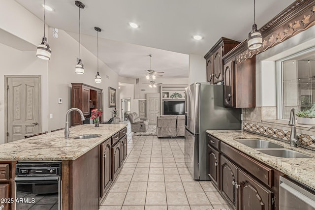 kitchen featuring light tile patterned flooring, ceiling fan, appliances with stainless steel finishes, and a sink