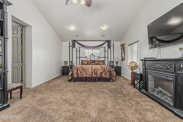 carpeted bedroom featuring baseboards, visible vents, and a fireplace
