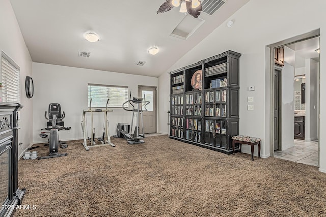 exercise room with light colored carpet, baseboards, visible vents, and vaulted ceiling