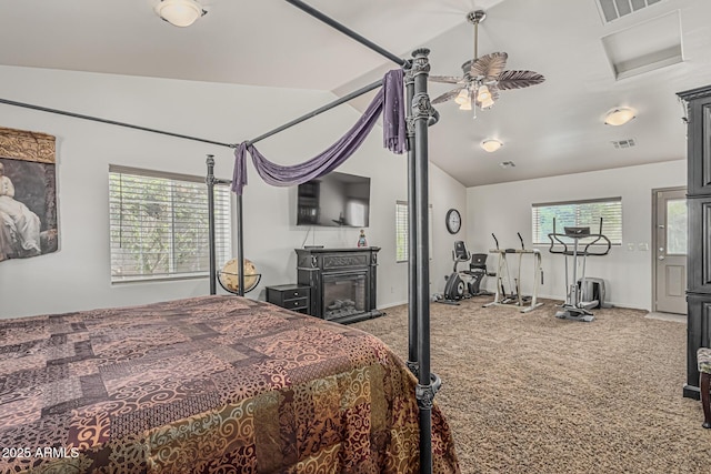 bedroom with vaulted ceiling, multiple windows, carpet flooring, and visible vents