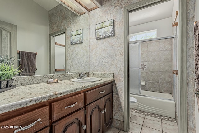 bathroom with toilet, enclosed tub / shower combo, tile patterned flooring, and vanity