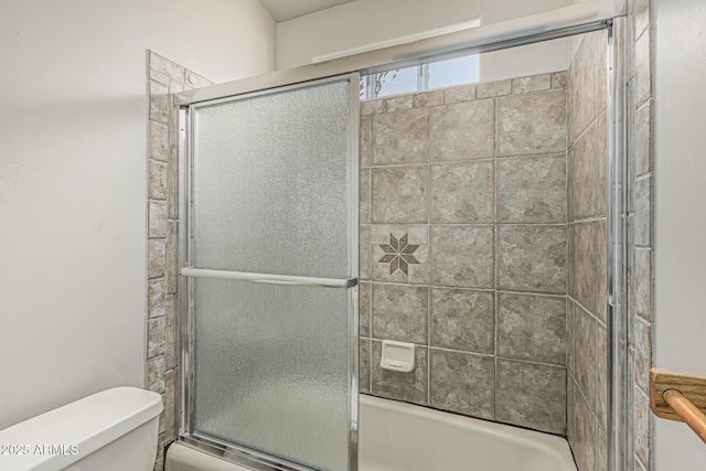 bathroom with toilet and enclosed tub / shower combo