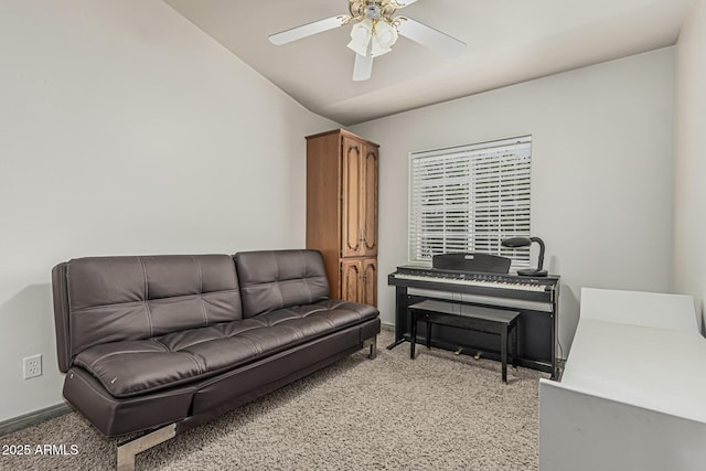living area with baseboards, ceiling fan, lofted ceiling, and light carpet