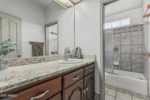 full bath with vanity, bath / shower combo with glass door, and toilet