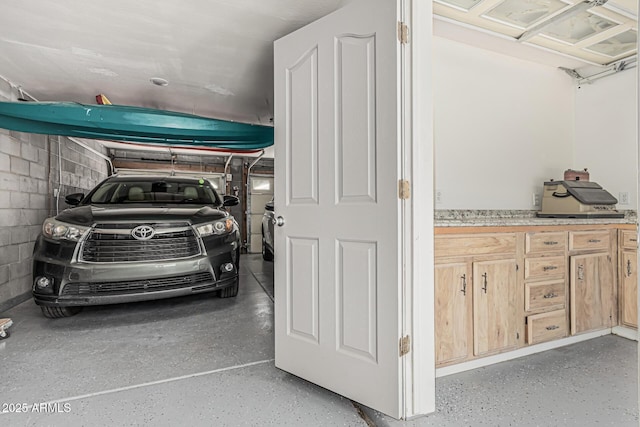 garage with concrete block wall