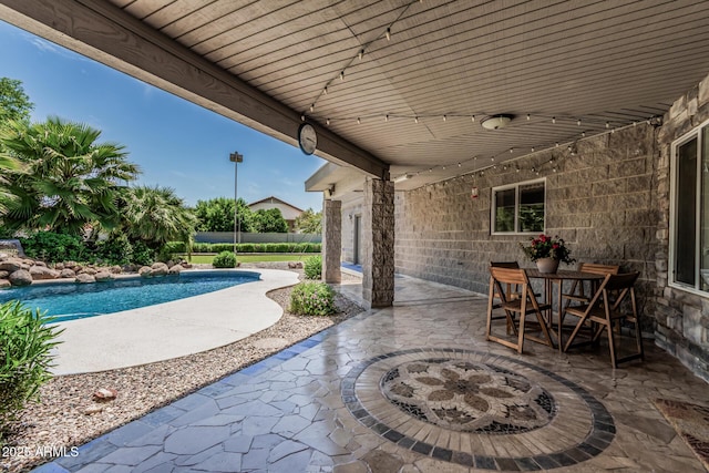 view of patio / terrace with a fenced in pool and a fire pit