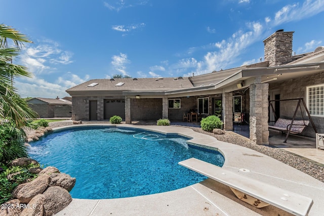 view of swimming pool with a fenced in pool, a diving board, and a patio area