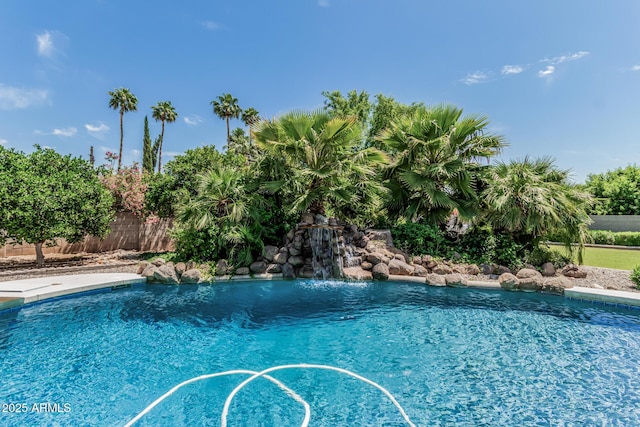 view of swimming pool with fence and a fenced in pool