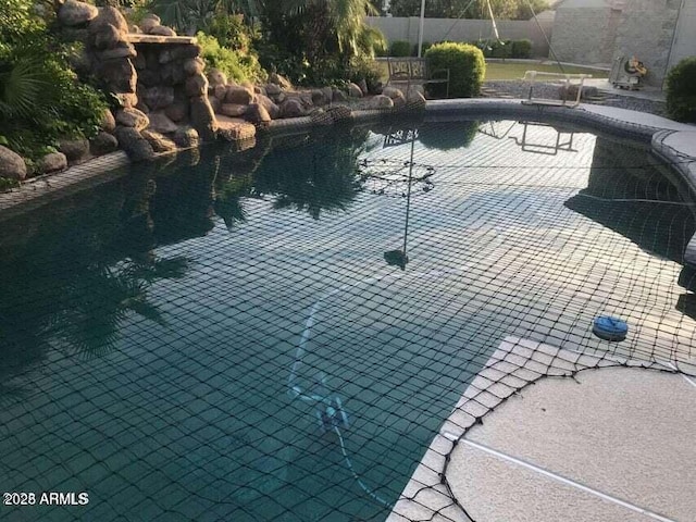 view of swimming pool with a fenced in pool