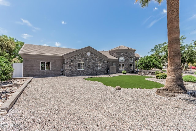 french country home featuring stone siding