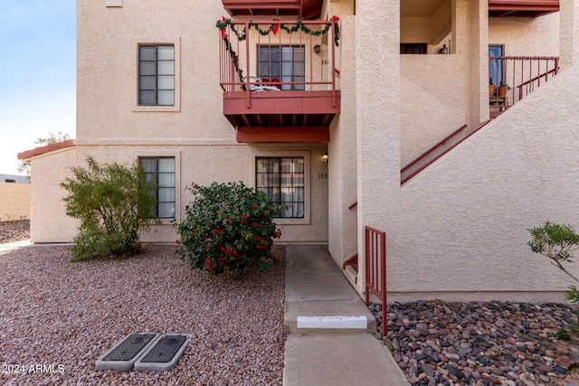 exterior space with a balcony and stucco siding