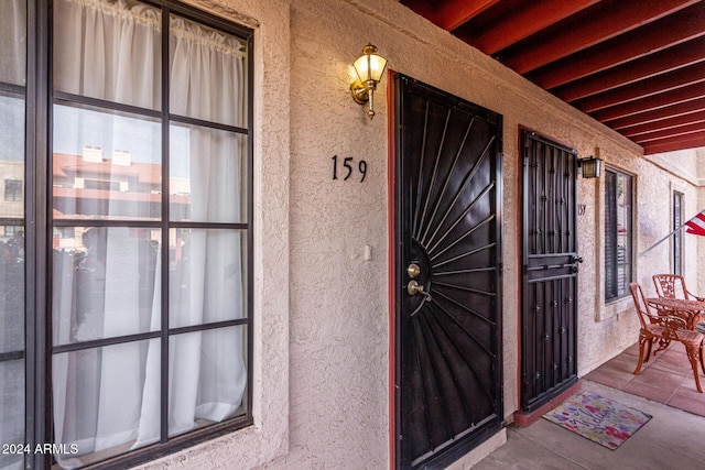 property entrance featuring stucco siding