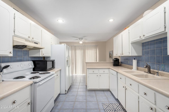 kitchen featuring light countertops, white appliances, white cabinetry, and under cabinet range hood