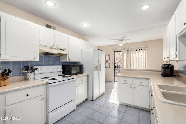 kitchen with white appliances, light countertops, under cabinet range hood, and white cabinets