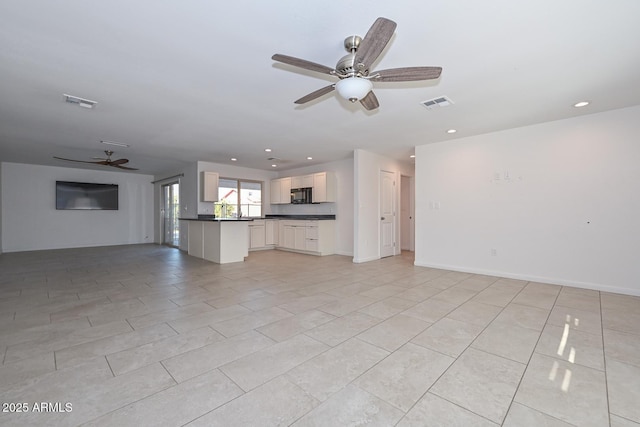 unfurnished living room featuring light tile patterned flooring and ceiling fan