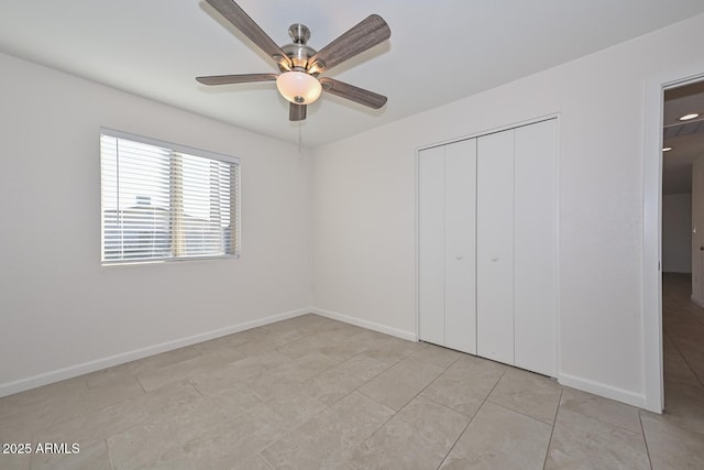 unfurnished bedroom with ceiling fan, a closet, and light tile patterned floors