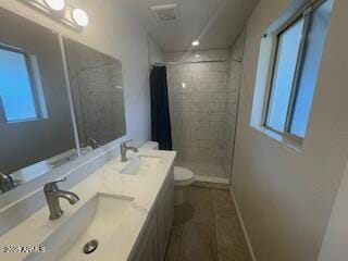 bathroom featuring walk in shower, tile patterned floors, vanity, and toilet