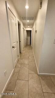 hall featuring light tile patterned flooring