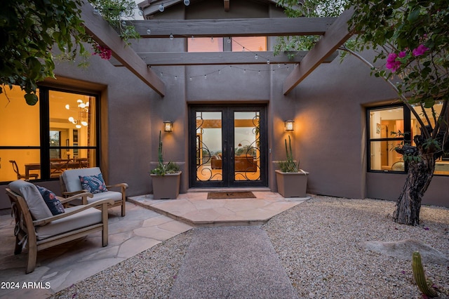 rear view of house with a patio area, a pergola, and french doors