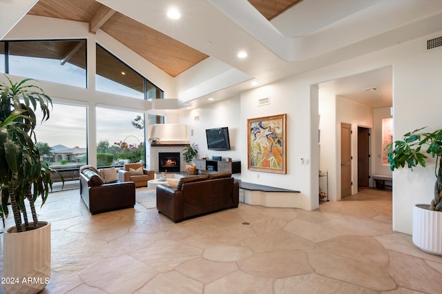 living room with high vaulted ceiling, beam ceiling, and wooden ceiling