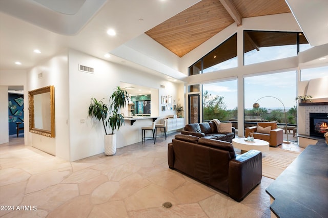 living room with a fireplace, wood ceiling, beamed ceiling, and high vaulted ceiling