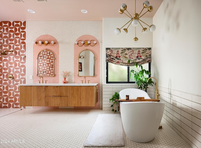 bathroom featuring a tub, vanity, and tile walls