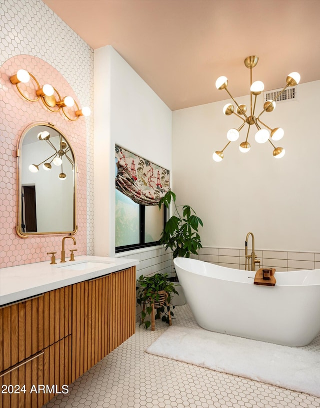 bathroom featuring a tub to relax in, vanity, tile walls, and tile patterned floors