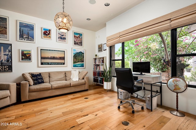 office featuring light wood-type flooring and a notable chandelier