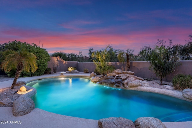 view of pool at dusk