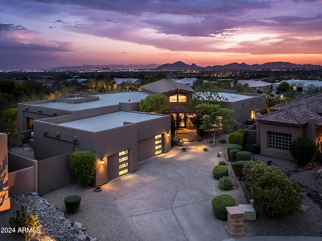 aerial view at dusk featuring a mountain view