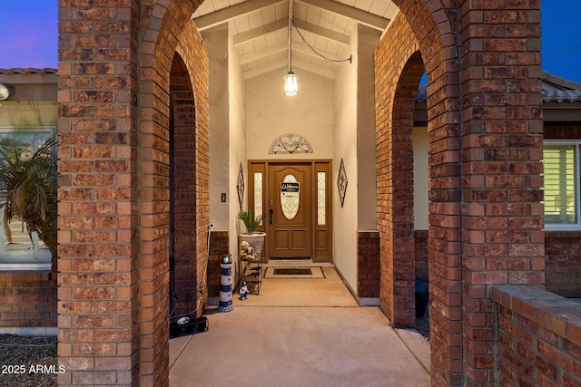 doorway to property featuring brick siding