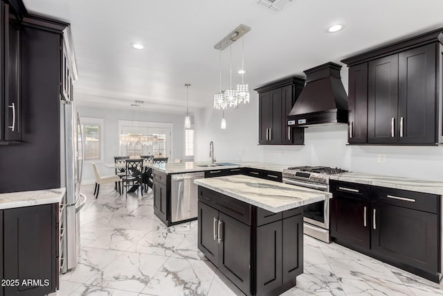 3316 E Fillmore St, Phoenix, AZ 85008 - kitchen featuring stainless steel appliances, custom exhaust hood, a peninsula, light marble finish flooring, and recessed lighting