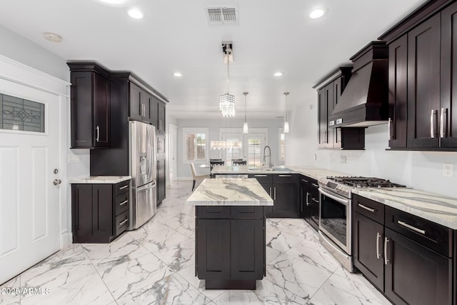 3316 E Fillmore St, Phoenix, AZ 85008 - kitchen with gas stove, custom exhaust hood, recessed lighting, a peninsula, and light stone counters