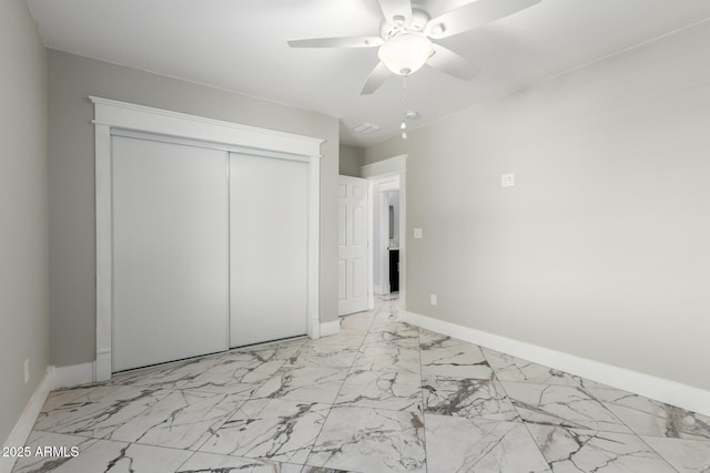 3316 E Fillmore St, Phoenix, AZ 85008 - unfurnished bedroom with light marble finish flooring, a closet, and a ceiling fan