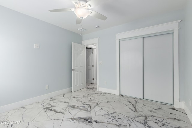 3316 E Fillmore St, Phoenix, AZ 85008 - unfurnished bedroom with marble finish floors, a closet, and a ceiling fan