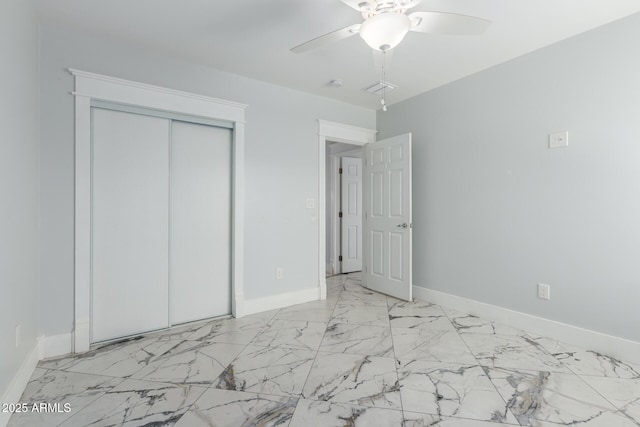 3316 E Fillmore St, Phoenix, AZ 85008 - unfurnished bedroom featuring light marble finish floors, a closet, and a ceiling fan