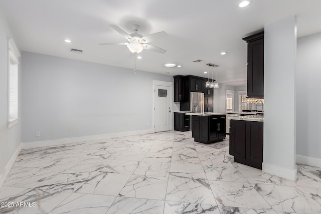 3316 E Fillmore St, Phoenix, AZ 85008 - kitchen featuring light countertops, a kitchen island, dark cabinetry, ceiling fan, and recessed lighting
