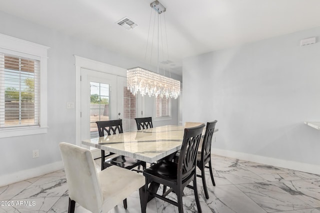 3316 E Fillmore St, Phoenix, AZ 85008 - dining room featuring marble look tiles and a chandelier